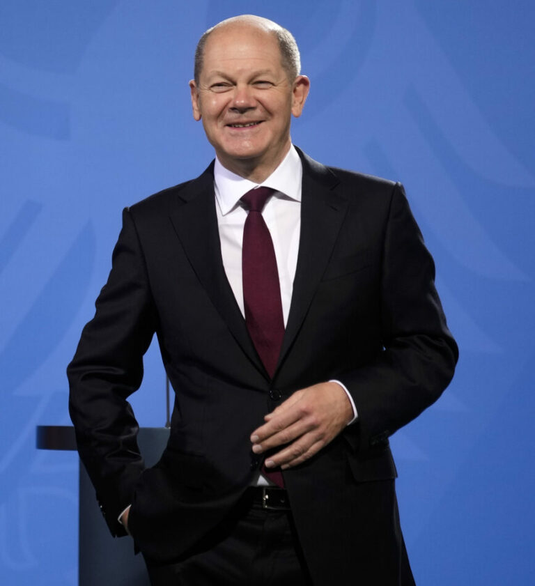 New elected German Chancellor Olaf Scholz laughs during a handover ceremony in the chancellery in Berlin, Wednesday, Dec. 8, 2021. (Photo/Markus Schreiber)