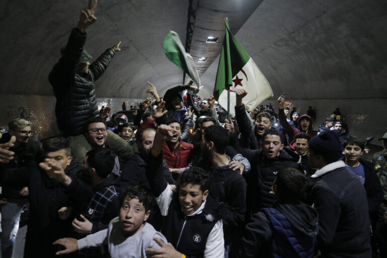 Algerian soccer fans celebrate Algeria's victory over Morocco after the Arab Cup quarterfinal Algeria against Morocco, early Sunday Dec.12, 2021 in Algiers. Algeria defeated Morocco following the penalty kicks after a 2-2 draw and advanced to the semifinals of the Arab Cup. (AP Photo/Toufik Doudou)