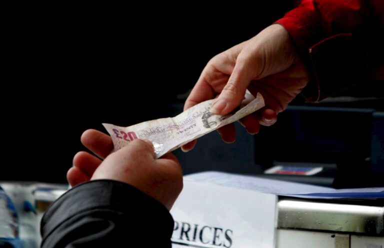 epa01281839 Money changes hands at a track-side bookmaker as racegoers place their bets on the opening day of the Cheltenham Horse Racing Festival l 11 March, 2008. The most prestigious meeting in the National Hunt (jump) racing calendar in the United Kingdom will see 25 five races over an four day period, with 55,000 people making the trip to the racecourse on a daily basis. EPA/ANITA MARIC UK AND IRELAND OUT