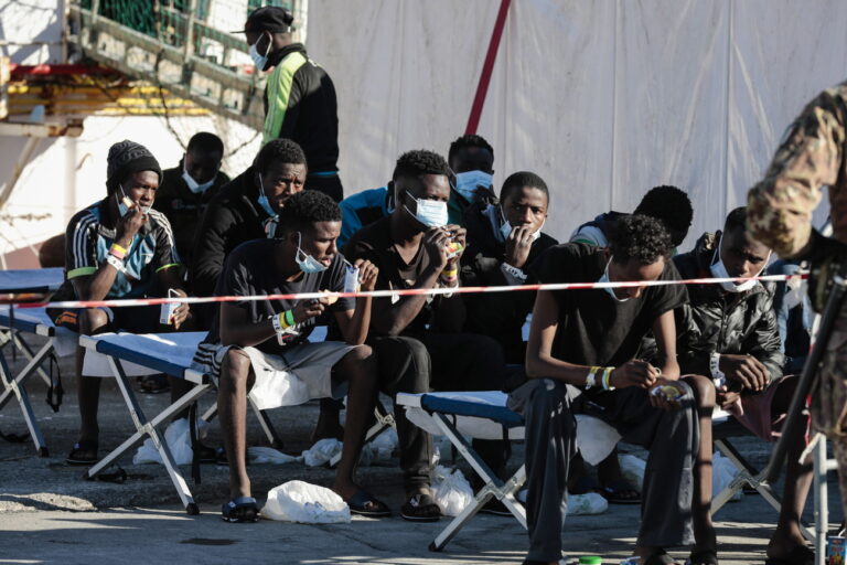 epa09662409 Some of the 440 migrants disembark from 'SeaWatch 3' who entered port the previous day, in Pozzallo, Sicily, Italy, 01 January 2022. The German NGO migrant rescue ship Sea Watch 3 with 440 migrants on board arrived on 31 December 2021 in the port of Pozzallo. The ship was at sea since Christmas Eve after carrying out five rescue missions. EPA/FRANCESCO RUTA