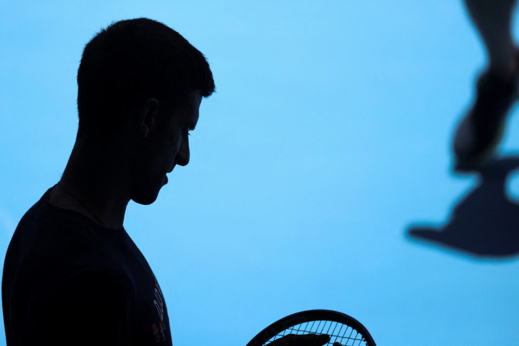 Serbian tennis player Novak Djokovic practices at Melbourne Park as questions remain over the legal battle regarding his visa to play in the Australian Open in Melbourne, Australia, January 12, 2022. REUTERS/Loren Elliott (KEYSTONE/REUTERS/LOREN ELLIOTT)