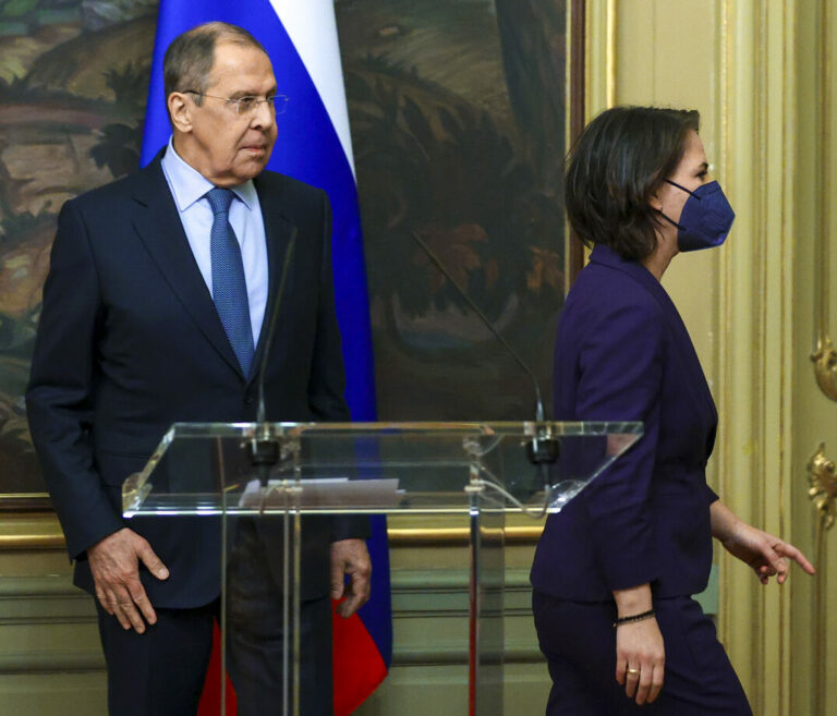 In this handout photo released by Russian Foreign Ministry Press Service, Russian Foreign Minister Sergey Lavrov and German Foreign Minister Annalena Baerbock leave a joint news conference following their talks in Moscow, Russia, Tuesday, Jan. 18, 2022. (Russian Foreign Ministry Press Service via AP)