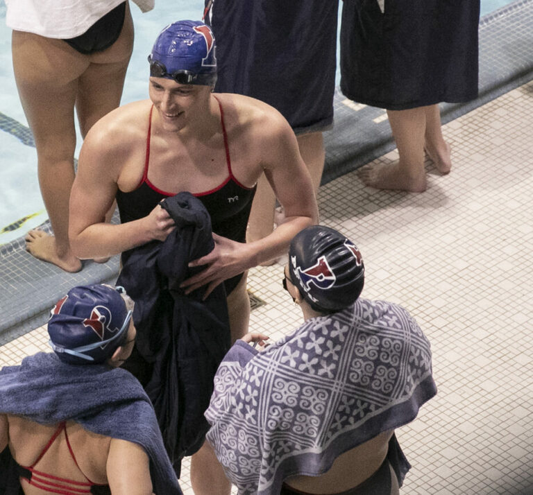 Penn swimmer Lia Thomas smiles with teammates after finishing first in a 200m women's race in Philadelphia, Saturday, Jan. 8, 2022. The NCAA has adopted a sport-by-sport approach for transgender athletes, bringing the organization in line with the U.S. and International Olympic Committees. NCAA rules on transgender athletes returned to the forefront when Penn swimmer Lia Thomas started smashing records this year. (Heather Khalfia/The Philadelphia Inquirer via AP)