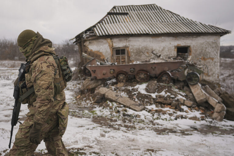 A Ukrainian serviceman provides area security during a visit by Gen. Oleksandr Pavliuk, commander of the Joint Forces Operation, to frontline positions outside Avdiivka, Donetsk region, eastern Ukraine, Wednesday, Feb. 9, 2022. (AP Photo/Vadim Ghirda)