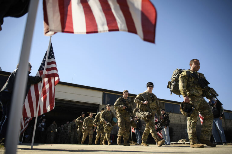 Paratroopers from Fort Bragg's 82nd Airborne Division prepare to board a plane from Fort Bragg, N.C., on Monday, Feb. 14, 2022. They are among soldiers the Department of Defense is sending in a demonstration of American commitment to NATO allies worried at the prospect of Russia invading Ukraine. (Andrew Craft/The Fayetteville Observer via AP)