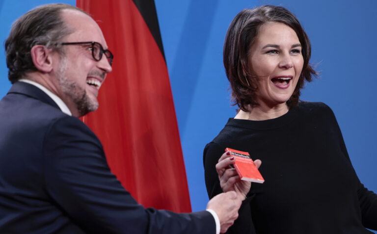 epa09763168 German Foreign Minister Annalena Baerbock, right, receives an Austrian-German dictionary from her counterpart from Austria Alexander Schallenberg before a meeting at the Foreign Ministry in Berlin, Germany, 16 February 2022. EPA/Hannibal Hanschke / POOL POOL PHOTO