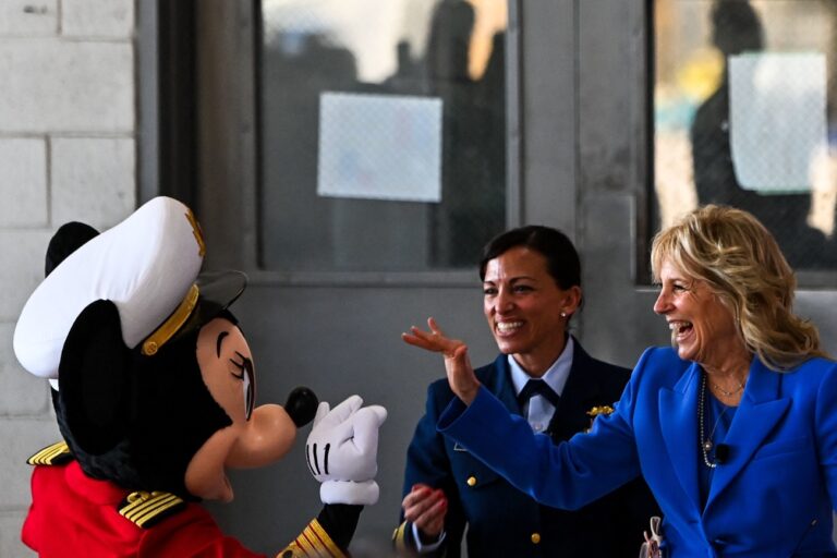 US First Lady Jill Biden greets Captain Minnie Mouse at the US Coast Guard Air Station Miami in Opa-locka, Florida on February 18, 2022. - The First Lady visits the U.S. Coast Guard Air Station Miami in Opa-locka for a private listening session with military families and book reading event in partnership with Disney and Blue Star Families to bring 