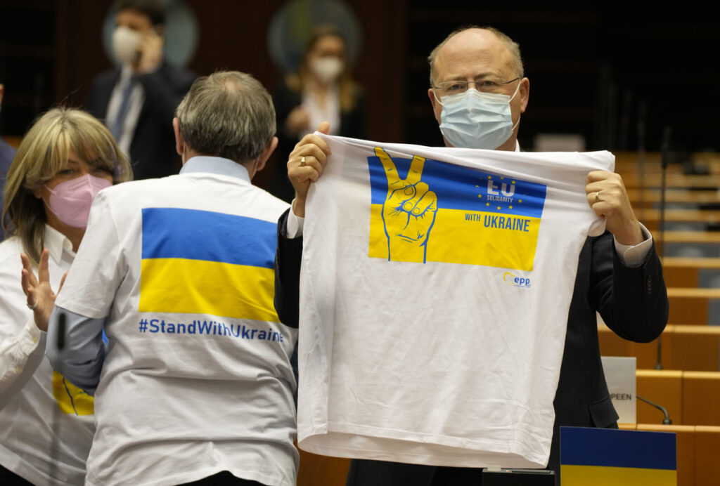 Members of European Parliament wear and hold shirts in support of Ukraine during an extraordinary plenary session on Ukraine at the European Parliament in Brussels, Tuesday, March 1, 2022. The European Union's legislature meets in an extraordinary session to assess the war in Ukraine and condemn the invasion of Russia. EU Commission President Ursula von der Leyen and Council President Charles Michel will be among the speakers. (AP Photo/Virginia Mayo)
