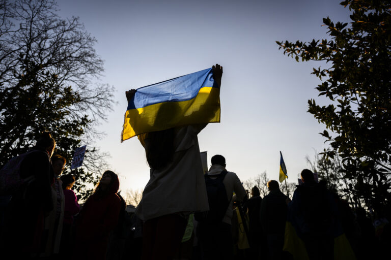 A protestor carries a flag during a demonstration against the Russian invasion of Ukraine in front of the Permanent Mission of the Russian Federation to the United Nations, in Geneva, Switzerland, on Thursday, 24 March 2022. (KEYSTONE/Gabriel Monnet)