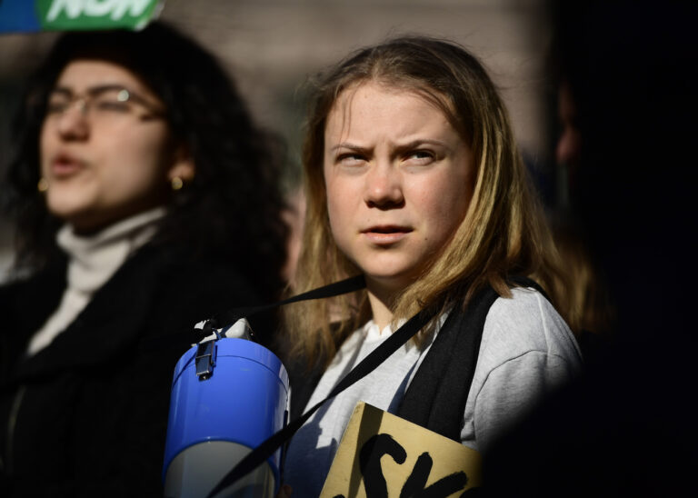 Activist Greta Thunberg takes part in a Fridays For Future school strike for climate and social justice march through Stockholm, Friday, March 25, 2022. Climate activists staged a tenth series of worldwide protests Friday to demand leaders take stronger action against global warming, with some linking their environmental message to calls for an end to the war in Ukraine. (Paul Wennerholm/TT via AP)