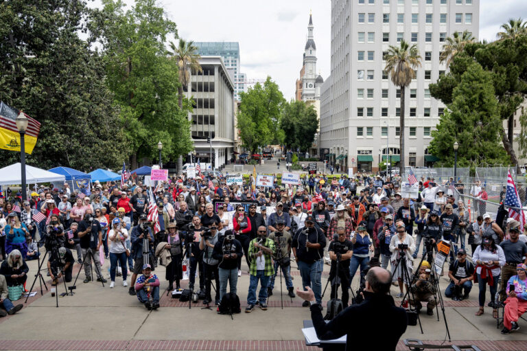 Silicon Valley entrepreneur Steve Kirsch, foreground right, founder of the anti-vaccine group Vaccine Safety Research Foundation, speaks against vaccine mandates to the crowd gathered Tuesday, April 19, 2022, at the state Capitol for The People's Convoy. (Sara Nevis/The Sacramento Bee via AP)