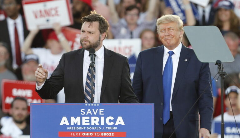 epa09905601 Former US President Donald Trump (R) gives his endorsement to Republican Ohio US Senate candidate J.D. Vance (L) during a Save America rally at the Delaware County Fairgrounds in Delaware, Ohio, USA, 23 April 2022. EPA/DAVID MAXWELL