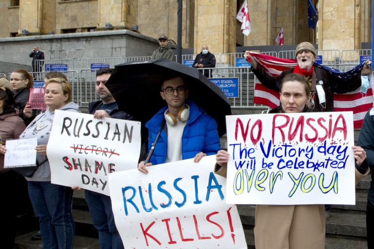 Demonstrators hold posters during an anti-war protest against the Russian invasion of Ukraine in Tbilisi, Georgia, Sunday, May 8, 2022, a day before Russia celebrates Victory Day, marking 77 years of the victory in WWII. (AP Photo/Shakh Aivazov)