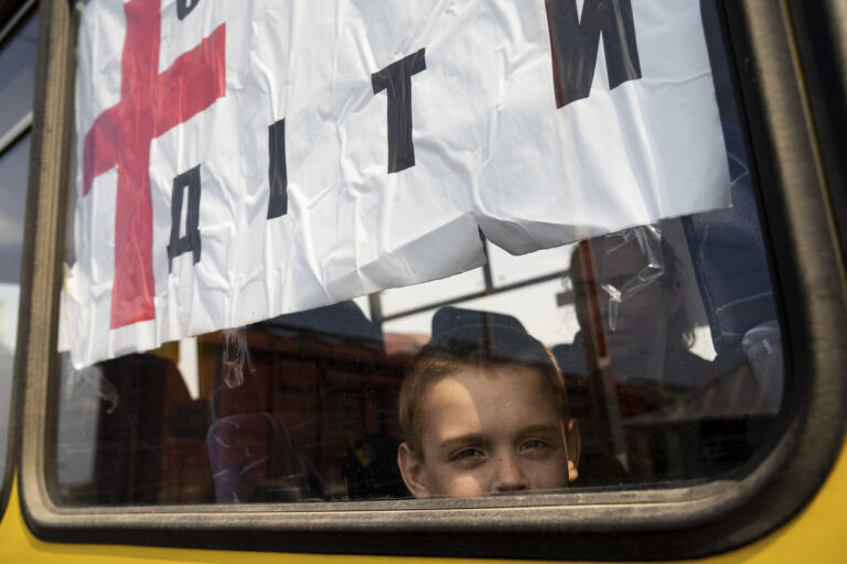 A boy from Siversk looks though the window of a bus during evacuation near Lyman, Ukraine, Wednesday, May 11, 2022. (AP Photo/Evgeniy Maloletka)