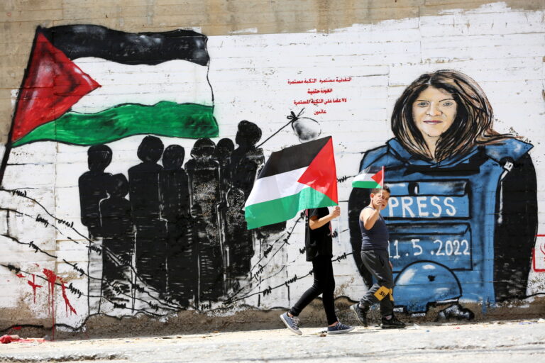 epaselect epa09950934 Palestinians walk in front of a mural for Al Jazeera journalist Shireen Abu Akleh in the West Bank city of Bethlehem, 16 May 2022. Al Jazeera journalist Shireen Abu Akleh was killed on 11 May 2022 during a raid by Israeli forces in the West Bank town of Jenin. EPA/ABED AL HASHLAMOUN