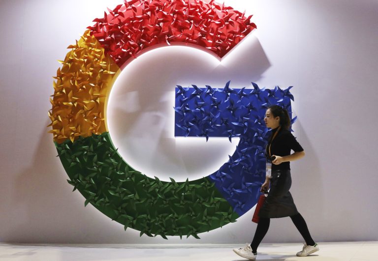 FILE - a woman walks past the logo for Google at the China International Import Expo in Shanghai, Nov. 5, 2018. Google says its Russian subsidiary is planning to file for bankruptcy because it canâÄ™t pay staff and suppliers. Russian state media reported Wednesday, May 18, 2022 that the U.S. tech companyâÄ™s Russian subsidiary submitted notice of its intention to declare bankruptcy to a national registry. (AP Photo/Ng Han Guan, File)