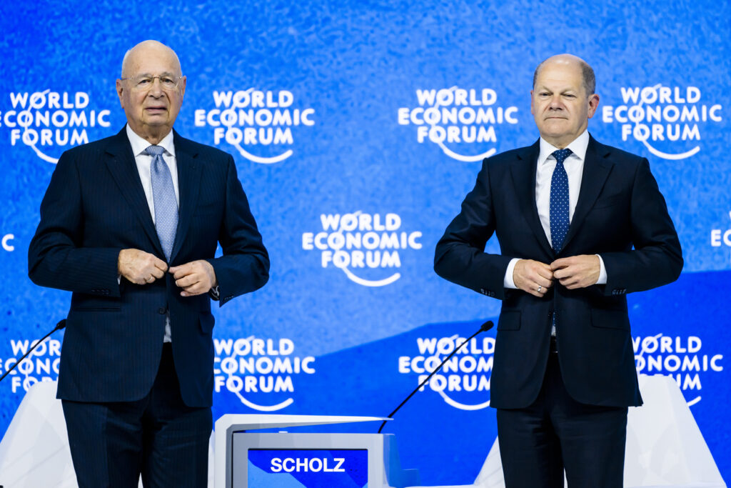 German Chancellor Olaf Scholz, right, reacts after he addresses a plenary session next to Klaus Schwab, Founder and Executive Chairman of the World Economic Forum during the 51st annual meeting of the World Economic Forum, WEF, in Davos, Switzerland, on Thursday, May 26, 2022. The forum has been postponed due to the Covid-19 outbreak and was rescheduled to early summer. The meeting brings together entrepreneurs, scientists, corporate and political leaders in Davos under the topic 
