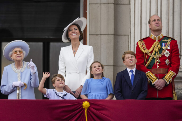 Queen Elizabeth II, from left, Prince Louis, Kate, Duchess of Cambridge, Princess Charlotte, Prince George and Prince William on the balcony of Buckingham Palace, London, Thursday June 2, 2022, on the first of four days of celebrations to mark the Platinum Jubilee. The events over a long holiday weekend in the U.K. are meant to celebrate the monarch's 70 years of service. (Alastair Grant/Pool Photo via AP)