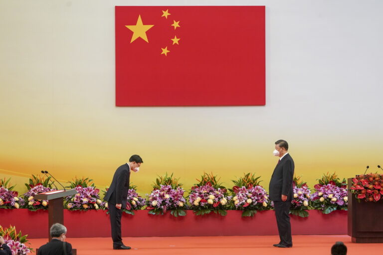 epa10045202 Hong Kong's new Chief Executive John Lee (L) bows to Chinese President Xi Jinping (R) at the Inaugural Ceremony of the Sixth-Term Government of the Hong Kong Special Administrative Region at the Hong Kong Convention and Exhibition Center in Hong Kong, China, 01 July 2022. Chinese President Xi Jinping is visiting the city to mark the 25th Anniversary of the establishment of the Hong Kong Special Administrative Region (HKSAR) of the People's Republic of China on 01 July 2022. EPA/FELIX WONG EDITORIAL USE ONLY / NO SALES