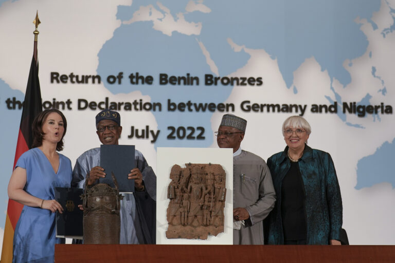 From left, German Foreign Minister Annalena Baerbock, Minister of Information and Culture of Nigeria Lai Mohammed, Nigerian Minister of State Foreign Affairs Zubairo Dada and German Government Commissioner for Culture and the Media Claudia Roth pose for media near two Benin Bronze sculptures after signing an agreement in Berlin, Germany, Friday, July 1, 2022. Germany and Nigeria signed an agreement in Berlin Friday paving the way for the return of centuries-old sculptures known as the Benin Bronzes that were taken from Africa in the 19th century and displayed in German museums and elsewhere. (AP Photo/Markus Schreiber)