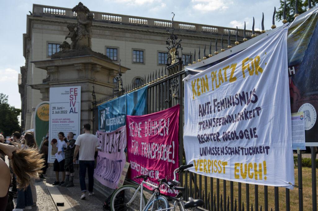 02 July 2022, Berlin: During a demonstration against the lecture of biologist Vollbrecht in a lecture hall of the Humboldt University as part of the Long Night of Science, banners hang in front of the main building of the Humboldt University. The university has organized the lecture, titled 