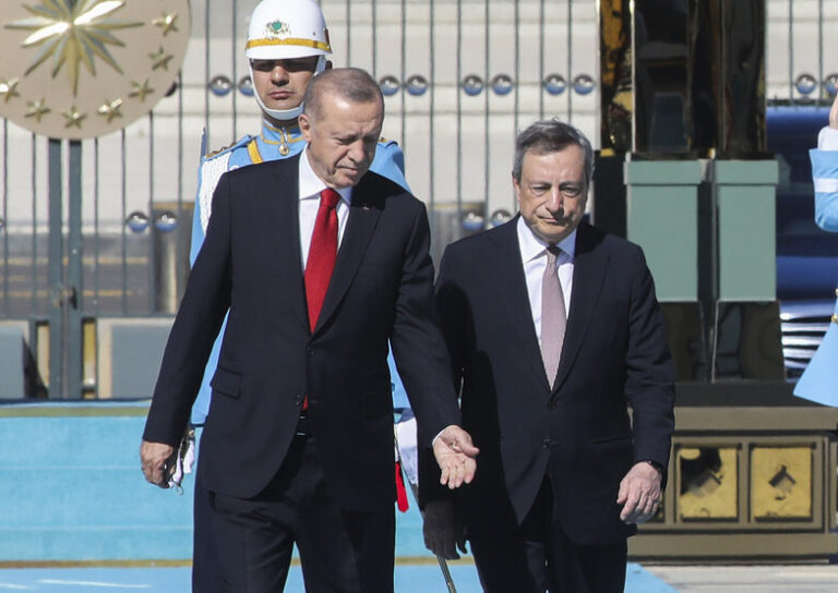Italy's Prime Minister Mario Draghi, right, is flanked by Turkey's President Recep Tayyip Erdogan as they review an honor guard at the Turkish Presidential palace in Ankara, Turkey, Tuesday, July 5, 2022. Draghi is on an official visit to Turkey. (AP Photo)