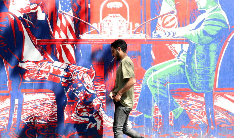 epa10161385 An Iranian man walks past an anti-US wall painting on the wall of former US embassy in the capital city of Tehran, Iran, 05 September 2022. Following the indirect exchange of responses through the EU representative between Iran and the United States regarding nuclear deal, Iran is now waiting for the US response to its latest nuclear proposal. Iran and the US has been exchanging their nuclear deal proposals indirectly through the EU, aimed at salvaging the 2015 nuclear deal with world powers. US says that will announce its answer to Iran's nuclear deal proposal in-time after reviewing all the aspects. One of the main Iran's demands is that all the sanctions against the country should be remove. Iran is facing economic crisis over sanctions by US and EU. EPA/ABEDIN TAHERKENAREH