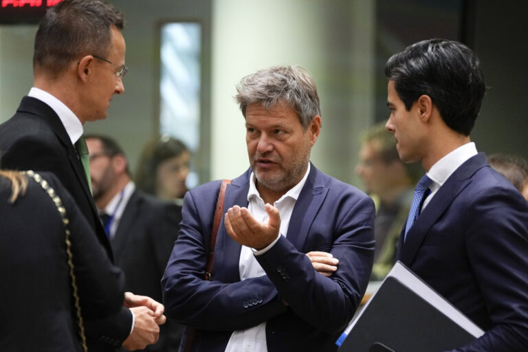 Germany Climate Action Minister Robert Habeck, center, speaks with Hungary's Foreign Minister Peter Szijjarto, left, and Netherland's Climate and Energy Minister Rob Jetten during a meeting of EU energy ministers in Brussels on Friday, Sept. 30, 2022. European Union energy ministers were set Friday to adopt a package of measures including a windfall levy on profits by fossil fuel companies, but a deal on capping gas prices remained off the table. (AP Photo/Virginia Mayo)