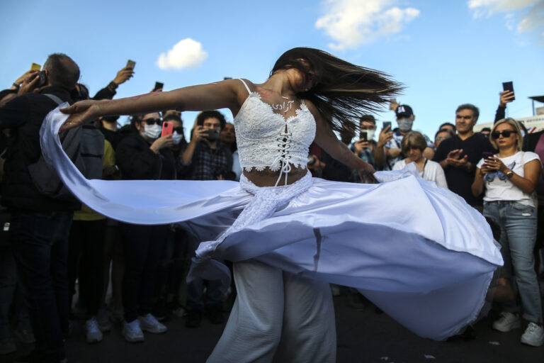 A woman dances during a protest against the death of Iranian Mahsa Amini, in Istanbul, Turkey, Sunday, Oct. 2, 2022. Thousands of Iranians have taken to the streets over the last two weeks to protest the death of Mahsa Amini, a 22-year-old woman who had been detained by Iran's morality police in the capital of Tehran for allegedly not adhering to Iran's strict Islamic dress code. (AP Photo/Emrah Gurel)
