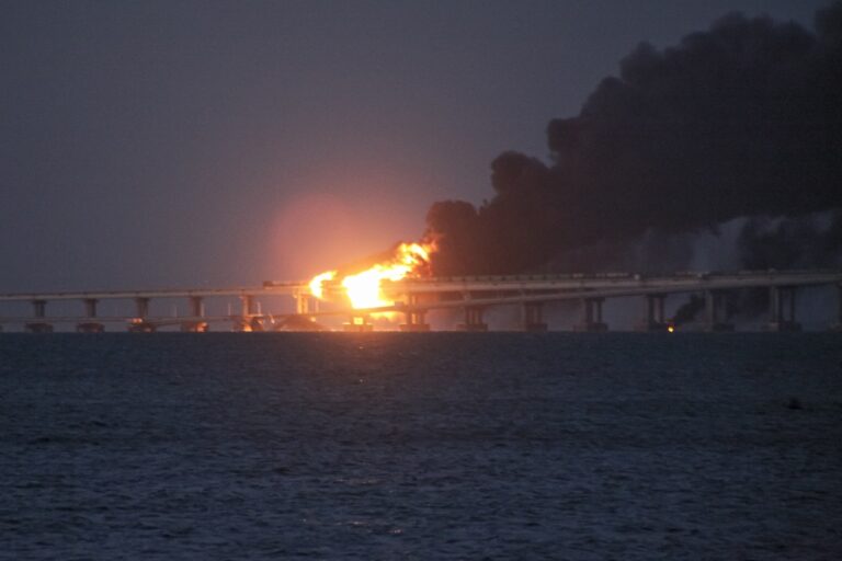 Flame and smoke rise from the Crimean Bridge connecting Russian mainland and the Crimean peninsula over the Kerch Strait, in Kerch, Crimea, early Saturday, Oct. 8, 2022. Russian authorities say a truck bomb has caused a fire and the partial collapse of a bridge linking Russia-annexed Crimea with Russia. The bridge is a key supply artery for Moscow's faltering war effort in southern Ukraine. (AP Photo)