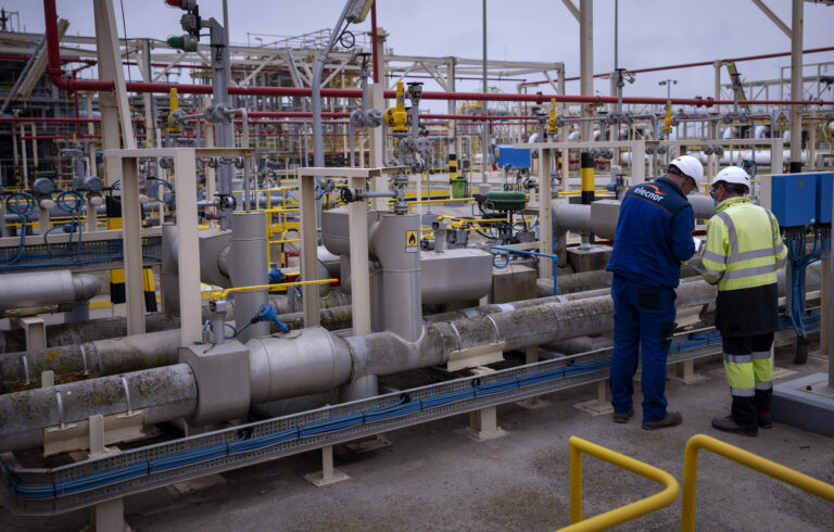 FILE - Operators work at Enagas regasification plant, the largest LNG plant in Europe, in Barcelona, Spain, March 29, 2022. Natural gas and electricity prices in Europe have plunged from summer peaks thanks to mild weather and a monthslong scramble to fill gas storage ahead of winter and replace Russian supplies during the war in Ukraine. It's a welcome respite after Russia slashed natural gas flows, triggering an energy crisis that has fueled record inflation and a looming recession. (AP Photo/Emilio Morenatti, File)