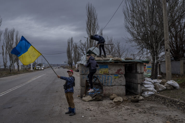 Ukrainian children play at an abandoned checkpoint in Kherson, southern Ukraine, Wednesday, Nov. 23, 2022. A new onslaught of Russian strikes on Ukrainian infrastructure on Wednesday caused power outages across the country âÄ” and in neighboring Moldova âÄ” further hobbling Ukraine's battered electricity network and compounding civilians' misery as winter advances. (AP Photo/Bernat Armangue)