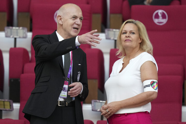 German Football Federation (DFB) President Bernd Neuendorf, left, talks to German Interior Minister Nancy Faeser, right, wearing the One Love armband on the tribune prior to the World Cup group E soccer match between Germany and Japan, at the Khalifa International Stadium in Doha, Qatar, Wednesday, Nov. 23, 2022. (AP Photo/Matthias Schrader)