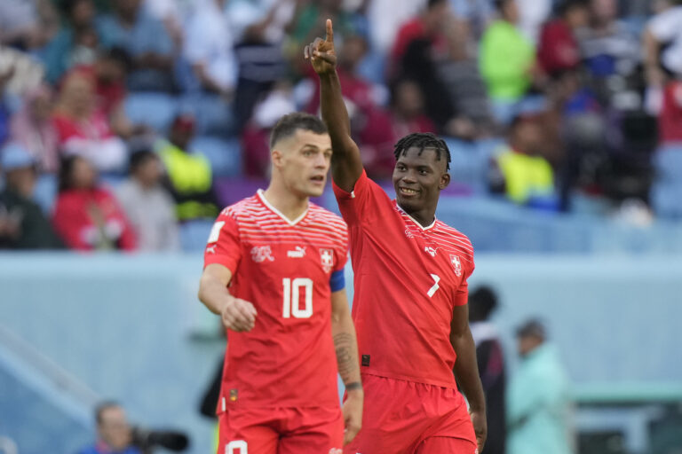 Switzerland's Breel Embolo, right, celebrates after scoring his side's opening goal during the World Cup group G soccer match between Switzerland and Cameroon, at the Al Janoub Stadium in Al Wakrah, Qatar, Thursday, Nov. 24, 2022. (AP Photo/Matthias Schrader)