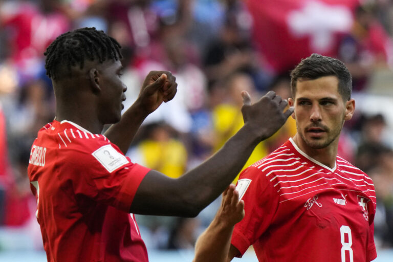 Switzerland's Breel Embolo, left, celebrates with teammate Remo Freuler after scoring then opening goal during the World Cup group G soccer match between Switzerland and Cameroon, at the Al Janoub Stadium in Al Wakrah, Qatar, Thursday, Nov. 24, 2022. Switzerland won 1-0. (AP Photo/Luca Bruno)