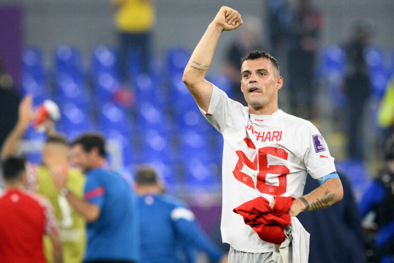 Switzerland's midfielder Granit Xhaka celebrates the victory and the qualification with the shirt of Switzerland's midfielder Ardon Jashari after the FIFA World Cup Qatar 2022 group G soccer match between Serbia and Switzerland at the Stadium 974, in Doha, Qatar, Saturday, December 3, 2022. (KEYSTONE/Laurent Gillieron)
