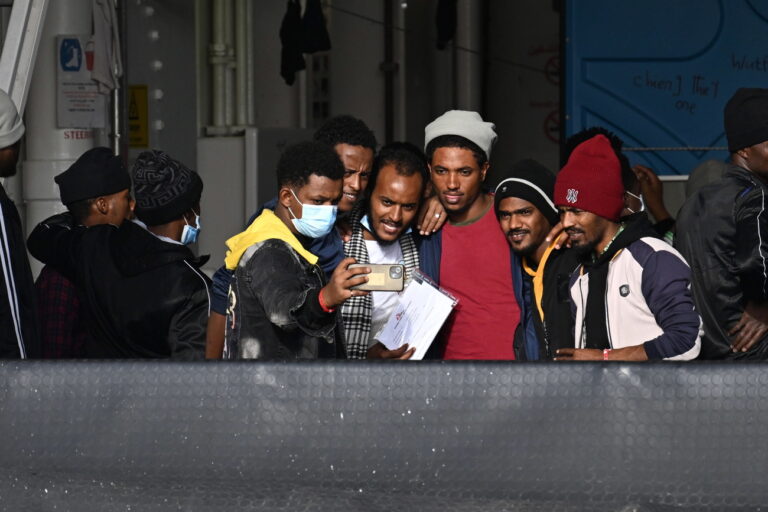 epa10360871 Migrants, among 248 migrants on board Ship Geo Barents, pose for a selfie upon arrival at Salerno's harbor, southeast of Naples, Italy, 11 December 2022. Migrant rescue ship Geo Barents, operated by the Doctors Without Borders (MSF) organization, was allowed to dock at Salerno port to disembark the 248 survivors currently on board, including women and children, the NGO said. EPA/Massimo Pica ITALY OUT