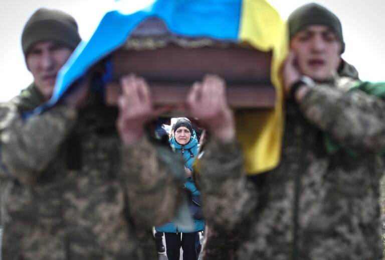 epa10364908 Ukrainian soldiers carry a coffin during the funeral ceremony of a comrade in Odesa, Ukraine, 29 March 2022. EPA/SEDAT SUNA