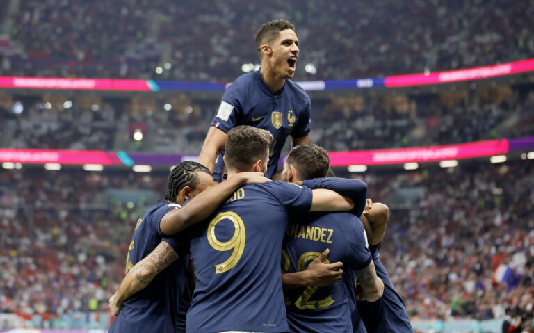 epa10365827 Raphael Varane of France (top) celebrates with teammates after the 1-0 scored by Theo Hernandez of (front-R) during the FIFA World Cup 2022 semi final between France and Morocco at Al Bayt Stadium in Al Khor, Qatar, 14 December 2022. EPA/Ronald Wittek