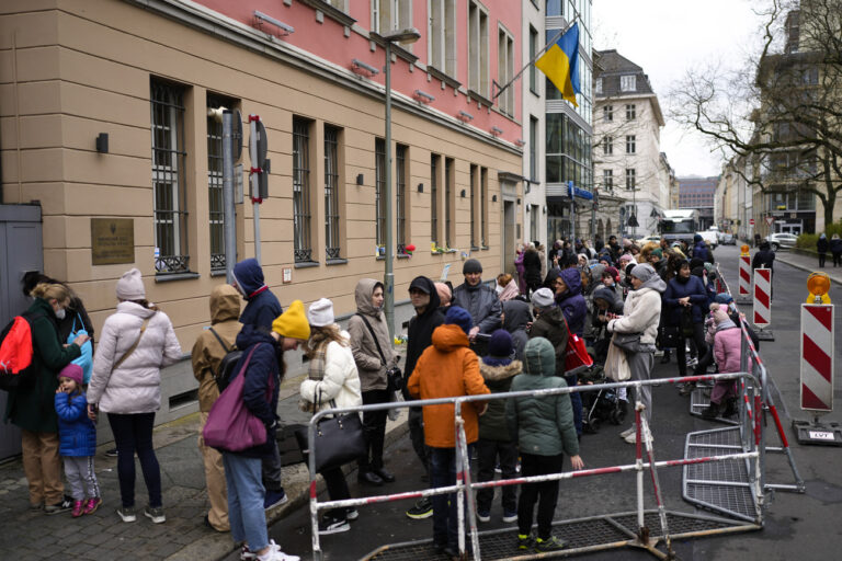 FILE - People from Ukraine, most of them refugees fleeing the war, wait in front of the consular department of the Ukrainian embassy in Berlin, Germany, on April 6, 2022. More than 244,000 people applied for asylum in Germany last year, and more than 1 million Ukrainian refugees came to the country looking for shelter from Russia's war, the government said Wednesday Jan. 11, 2023. (AP Photo/Markus Schreiber, File)