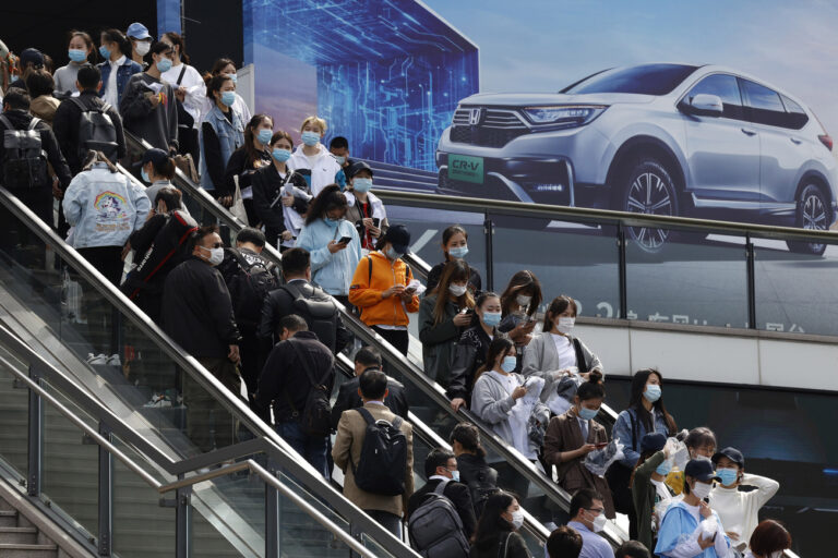 FILE - Visitors attend the Shanghai Auto Show in Shanghai on Wednesday, April 21, 2021. China's auto sales rose 9.5% in 2022 as electric vehicle purchases nearly doubled, but demand in the global industry's biggest market slumped in December, foreshadowing weaker growth this year, a trade group reported Thursday, Jan. 12, 2023. (AP Photo/Ng Han Guan, File)
