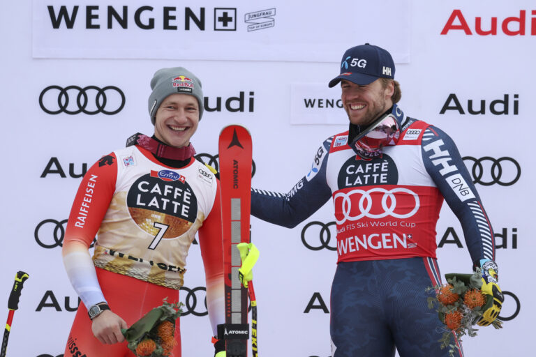 Norway's Aleksander Aamodt Kilde, right, congratulates second placed Switzerland's Marco Odermatt after an alpine ski, men's World Cup downhill, in Wengen, Switzerland, Saturday, Jan. 14, 2023. (AP Photo/Alessandro Trovati)