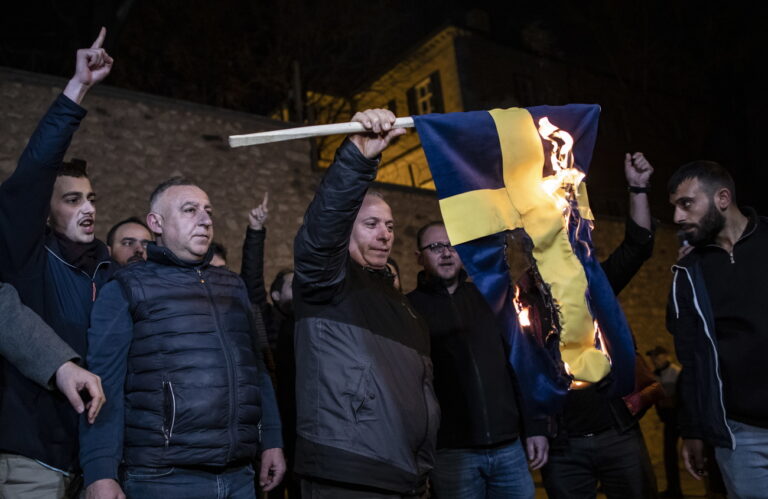 epa10421207 Protesters burn a Swedish flag in front of the Consulate General of Sweden during a protest in Istanbul, Turkey, 21 January 2023. Swedish-Danish far-right politician Rasmus Paludan was permitted to hold a demonstration and burn a copy of Koran in front of the Turkish embassy in Stockholm on 21 January. EPA/ERDEM SAHIN