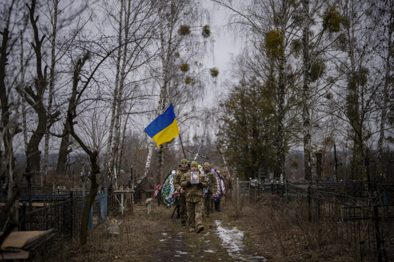 Ukrainian military officers carry the coffin of Kasich during his funeral procession in Bucha, near Kyiv, Ukraine, Friday, Feb. 17, 2023. Kasich Kostiantyn, 42, a senior lieutenant of 93rd Ukrainian brigade was killed on Tuesday, Feb. 14 in the fightings in Bakhmut area. (AP Photo/Emilio Morenatti)