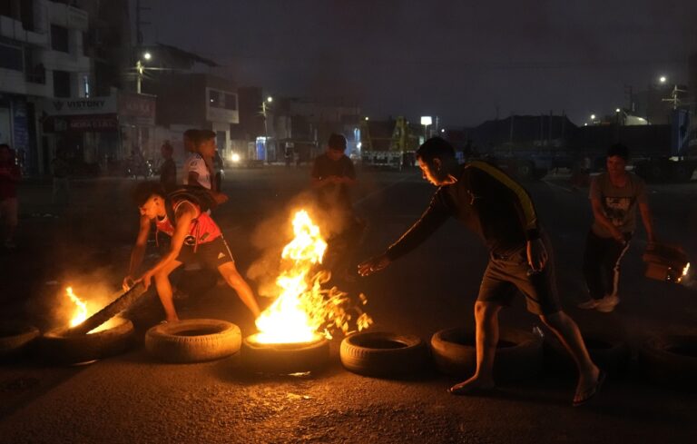 Demonstrators build a burning barricade to block a portion the Pan-American North Highway in Chao, Peru, Friday, Feb. 17, 2023. Peru is in the midst of a political crisis as protestors are seeking President Dina Boluarte's resignation and the dissolution of Congress after President Pedro Castillo was ousted and arrested for trying to dissolve Congress in December. (AP Photo/Martin Mejia)