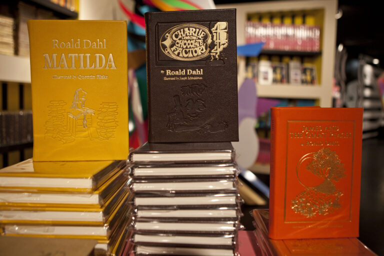 FILE - Books by Roald Dahl are displayed at the Barney's store on East 60th Street in New York on Monday, Nov. 21, 2011. Critics are accusing the publisher of Roald Dahl's classic children's books of censorship after it removed colorful language from stories such as “Charlie and the Chocolate Factory” and “Matilda” to make them more acceptable to modern readers. (AP Photo/Andrew Burton, File)
