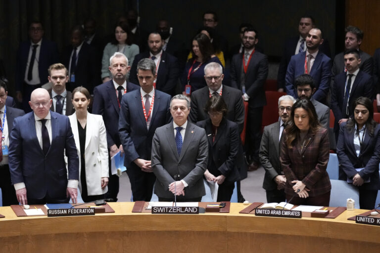 Swiss Federal Council Ignazio Cassis at the Security Council meeting rise for a moment of silence at United Nations headquarters, Friday, Feb. 24, 2023. (AP Photo/Seth Wenig)