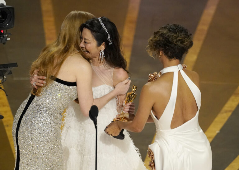 Jessica Chastain, left, and Halle Berry, right, present Michelle Yeoh with the award for best performance by an actress in a leading role for 