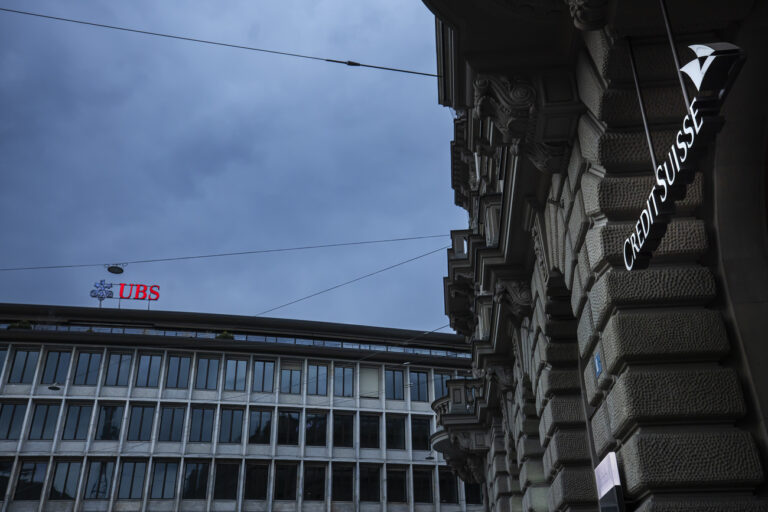 A general view shows the headquarters of the Swiss banks Credit Suisse, right, and UBS, left, at Paradeplatz in Zurich, Switzerland on Sunday March 19, 2023. (KEYSTONE/Michael Buholzer).