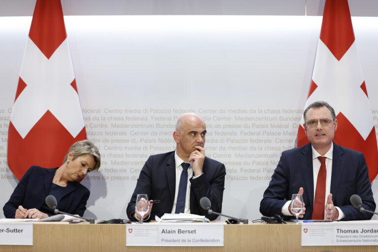 Thomas J. Jordan, Chairman Swiss National Bank, right, speaks beside Swiss Federal President Alain Berset, center, and Swiss Finance Minister Karin Keller-Sutter, during a press conference, on Sunday, 19 March 2023 in Bern. Switzerland's largest bank UBS agreed to take over Credit Suisse for 3 billion Swiss francs ($3.25 billion) in a government-brokered deal over the weekend following days of market upheaval over the health of the banking sector. (KEYSTONE/Peter Klaunzer)